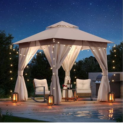 Gazebo with string lights and curtains by a pool at night